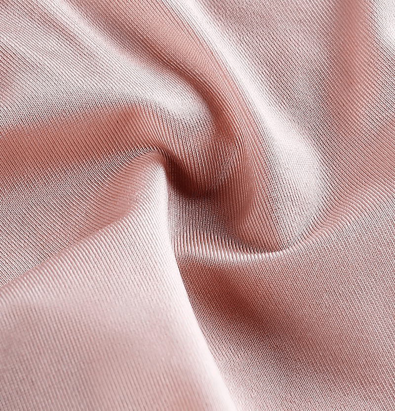 Close-up of silky, rose-colored fabric, showing smooth texture and light sheen, ideal for women's fitness underwear.